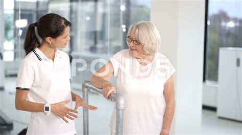 Physiotherapist Medical Nurse Helping Elderly Woman Stock Footagenursehelpingphysiotherapist