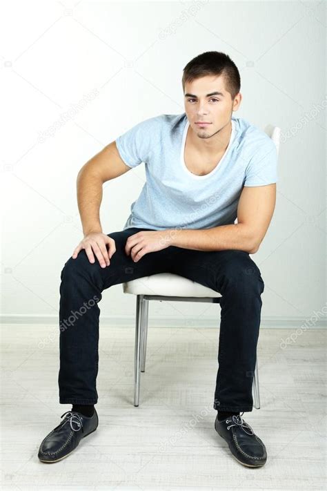 Guy Sitting On Chair In Room Stock Photo By ©belchonock 35695093