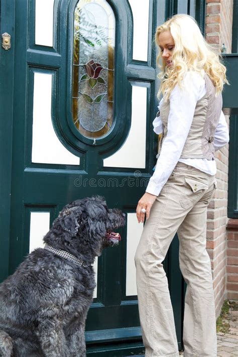 Young Woman And Her Dog In Front Of House Stock Photo Image Of Black