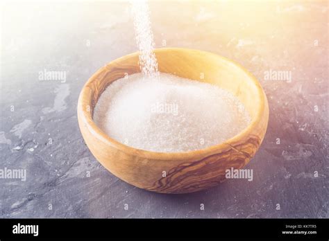 Sugar Grains Pouring And Overflowing A Bowl Stock Photo Alamy