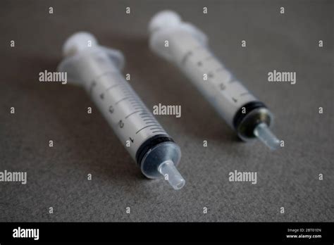 Some Small Syringes On A Grey Paper View Above Stock Photo Alamy