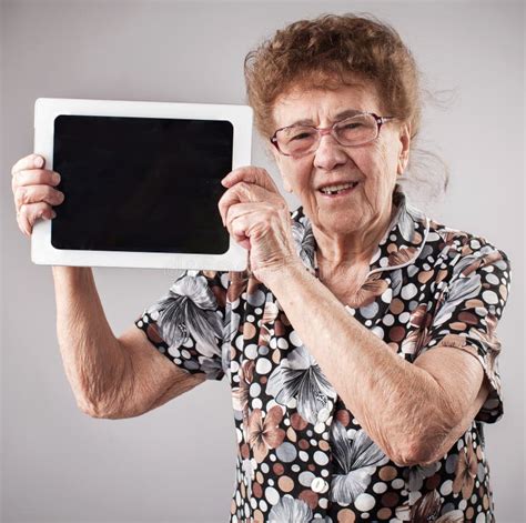 Old Woman Holding A Tablet In The Hands Of Stock Image Image Of Copy