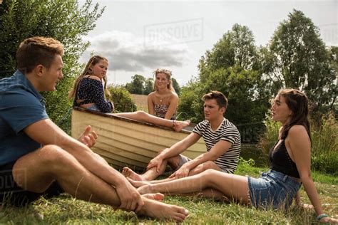 Friends Relaxing In Park Stock Photo Dissolve