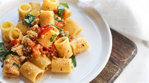 Combine 1 pint of cherry tomatoes with olive oil, pepper garlic cloves and salt in a baking dish. The TikTok Feta Pasta Everyone Is Talking About