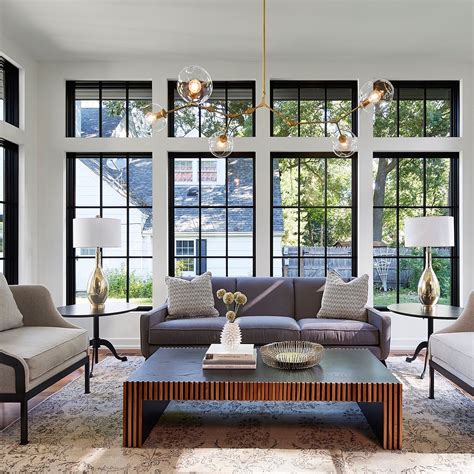 A Living Room Filled With Furniture And Lots Of Windows In Front Of