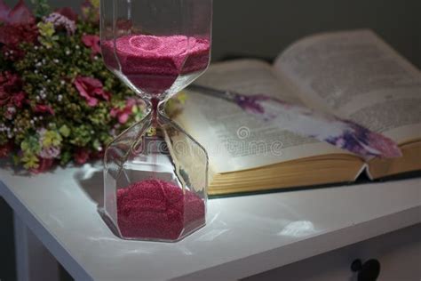 Still Life Hourglass Book Pen And A Bouquet Stock Photo Image Of