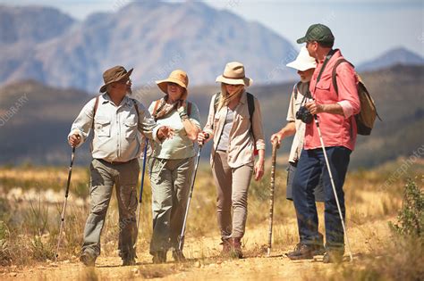 Active Senior Friends Hiking With Hiking Poles Stock Image F021