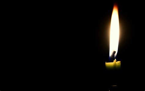 Close Up Of Illuminated Candle Against Black Background · Free Stock Photo