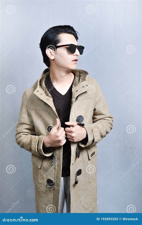 Vertical Shot Of An Asian Male Wearing Sunglasses And A Brown Jacket Stock Image Image Of