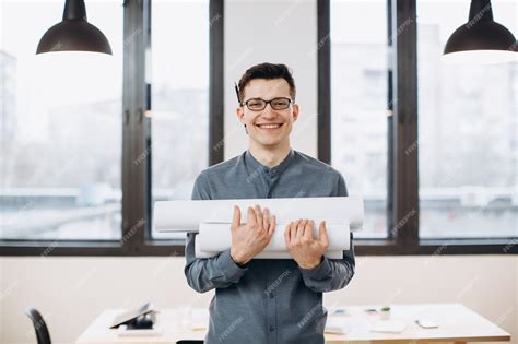 Premium Photo Attractive Young Man Architect In Glasses Standing