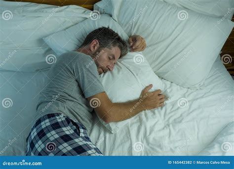 Domestic Lifestyle High Angle Portrait Of Young Attractive And Relaxed Man Sleeping Alone On Bed