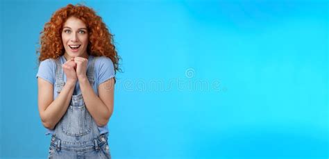 tender silly sensitive redhead emotive curly girl clench hands together touched smiling gasping