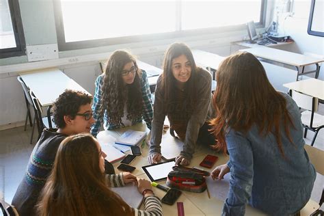 Group Of Young Students Doing Teamwork In A School Classroom By