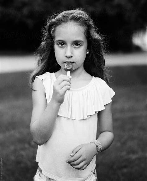 Black And White Portrait Of A Young Girl Eating A Popsicle By Jakob
