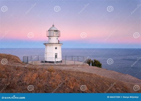 Beautiful White Lighthouse On The Ocean Coastline At Sunset Landscape