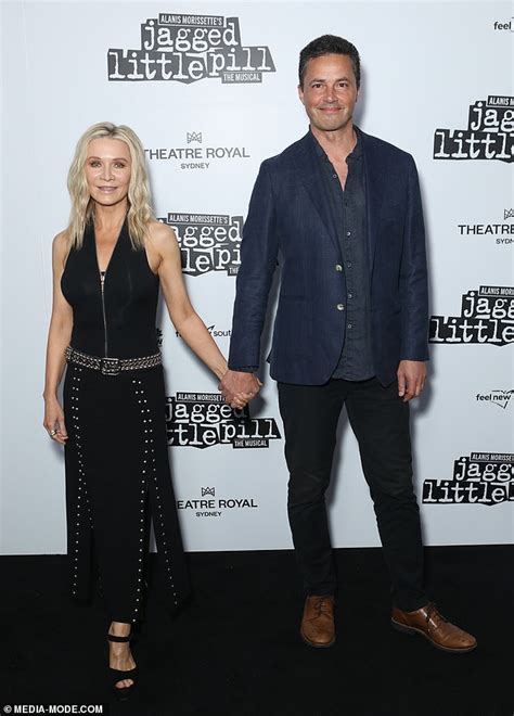 Danielle Spencer And Partner Adam Long Hold Hands At Opening Of Jagged