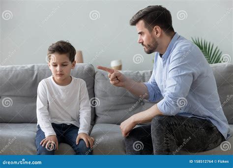 Angry Father Scolding Sad Kid Son For Bad Behavior Stock Photo Image