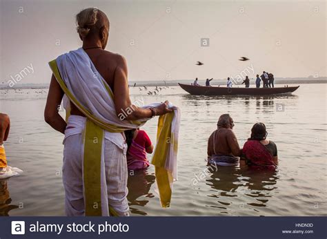 pilgrims praying and bathing in the ghats of ganges river varanasi uttar pradesh india stock