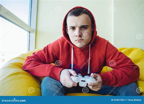 Portrait Of A Young Gamer With A Joystick In Their Hands Playing A