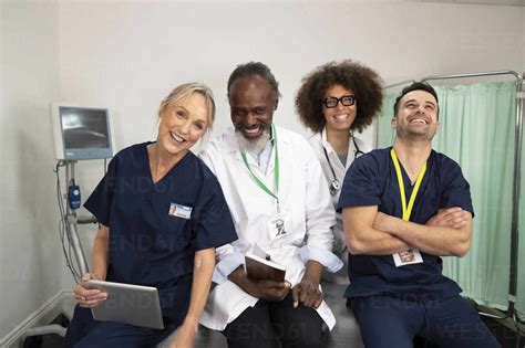 Cheerful Doctors And Nurses Together In Medical Room Stock Photo