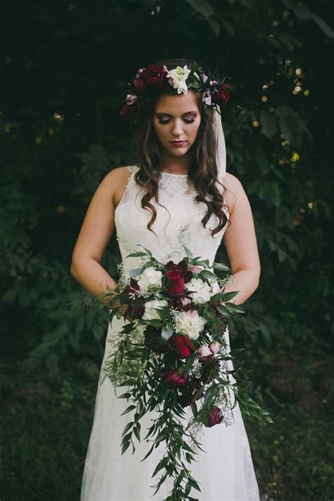 Natural and rustic this bouquet of burgundy and ivory flowers compliments a relaxed style individual mokara blooms and hypericum berries were strung onto gold wire to create a cascading 54. Fall bouquet. Burgundy bouquet. Organic bouquet. Tennessee ...
