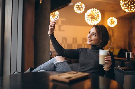 Premium Photo Woman In Cafe Doing Selfie And Drinking Coffee