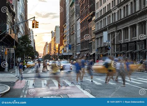 Busy People Walk Across The Crowded Intersection On 23rd Street And