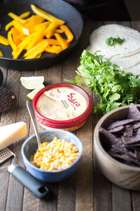 Mexican street corn is a staple of summer and it's easy to make at home! Mexican Street Corn Salsa Hummus - LemonsforLulu.com