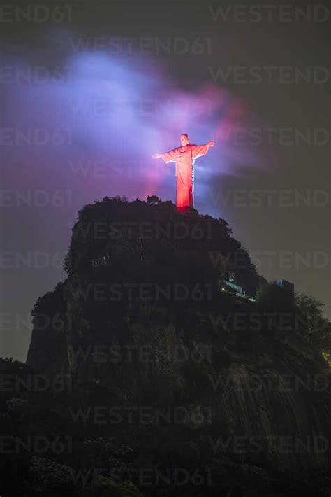 Christ The Redeemer Statue With Red Lights During Early Night
