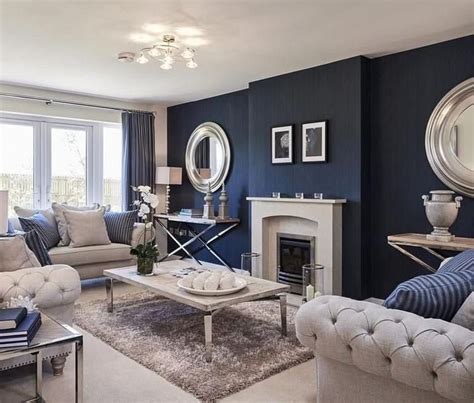 Blue beachy coastal living room design with vintage gray chest, pearl mirror, vertical art gallery, blue lamp, striped blue sofa, suzanne kasler quatrefoil chair and blue walls paint color. Pin by Sara Kobeissi on Lounge in 2020 | Blue living room decor, Blue walls living room, Living ...
