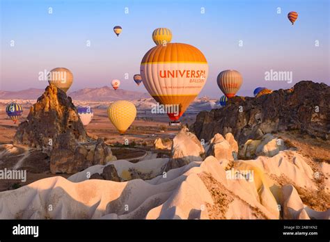 Flying Hot Air Balloons And Rock Landscape At Sunrise Time In Goreme