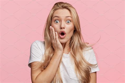 Indoor Shot Of Stupefied Shocked Blonde Woman Keeps Mouth Widely Opened Looks In Terror At