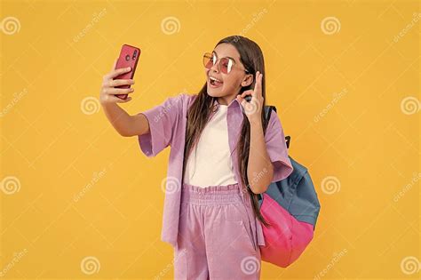 photo of surprised teen selfie school girl with phone teen selfie school girl isolated on