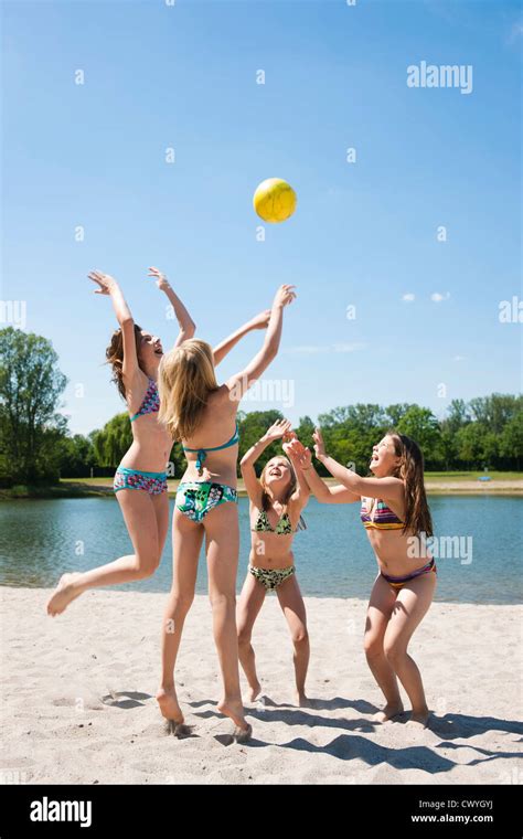 Four Girls In Bikinis Playing With Ball At Bathing Lake Stock Photo Alamy