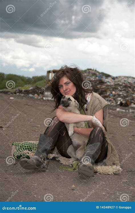 A Homeless Girl Is Standing On A Garbage Dump With A Houseplant In A Pot Royalty Free Stock