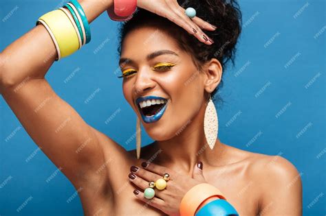 Free Photo Horizontal Lovely Mulatto Woman With Colorful Makeup And Curly Hair In Bun Smiling