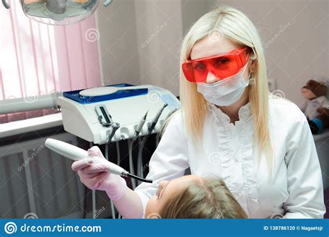 Female Dentist Examining Teeth In Dental Office Stock Photo Image Of