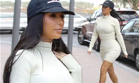 Kim Kardashian Shows Off Her Shapely Rear In A Form Fitting White Dress