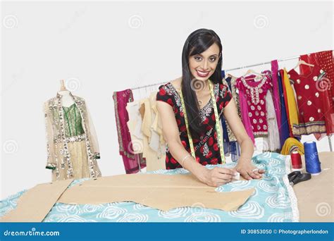 Portrait Of Beautiful Indian Female Fashion Designer Working Stock