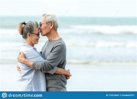 Asian Lifestyle Senior Couple Hug And Kiss On The Beach Happy In Love