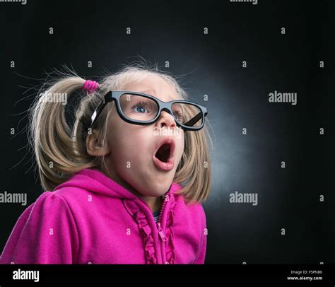 Little Astonished Girl In Funny Big Spectacles On Grey Background Stock