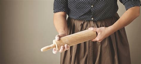 Free Photo Woman Holds Wooden Rolling Pin In Hands And Rubs It With Flour