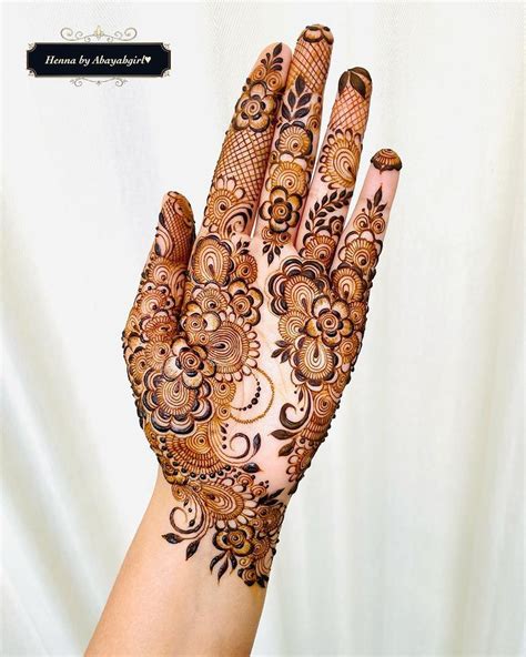 A Womans Hand With Henna On It Showing The Intricate Pattern And Design