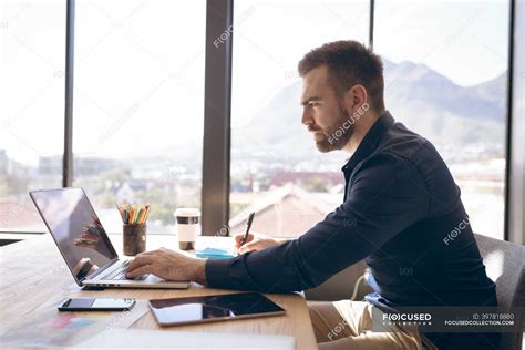Side View Of A Caucasian Businessman Working In A Modern Office