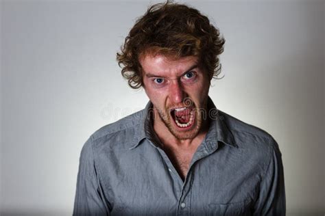 Young Man Screams In Anger On Gray Background Stock Photo Image Of
