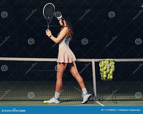 Female Tennis Player Posing On An Indoor Tennis Court Stock Image