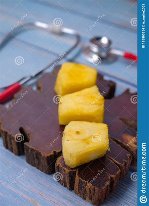 Pineapple Sliced And Stethoscope On Wooden Background Care And