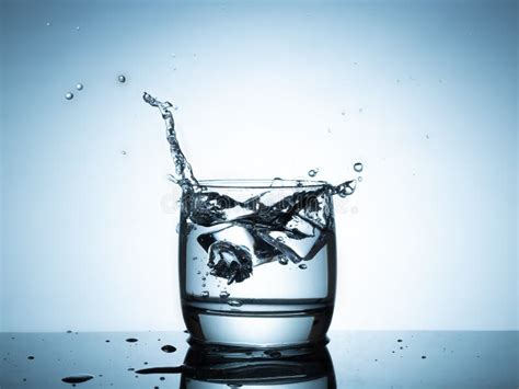 Ice Cubes Splashing Into Glass Of Water Stock Image Image Of Motion