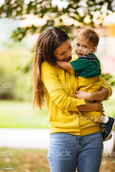 Beautiful Young Mother Holding Her Baby Boy Stock Photo Download