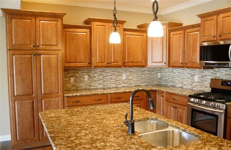 For a fresh, bright look, choose white ceramic or vinyl tiles to create a cottage look for your kitchen. Modern backsplash with traditional cabinets | Maple ...